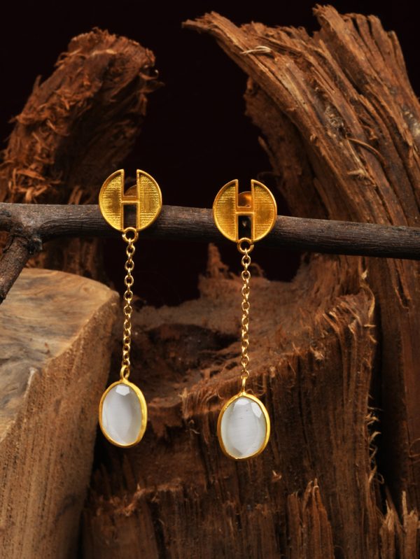 Luminous gold plated stud & striking white colour stone initiate this pair of contemporary tassel earring